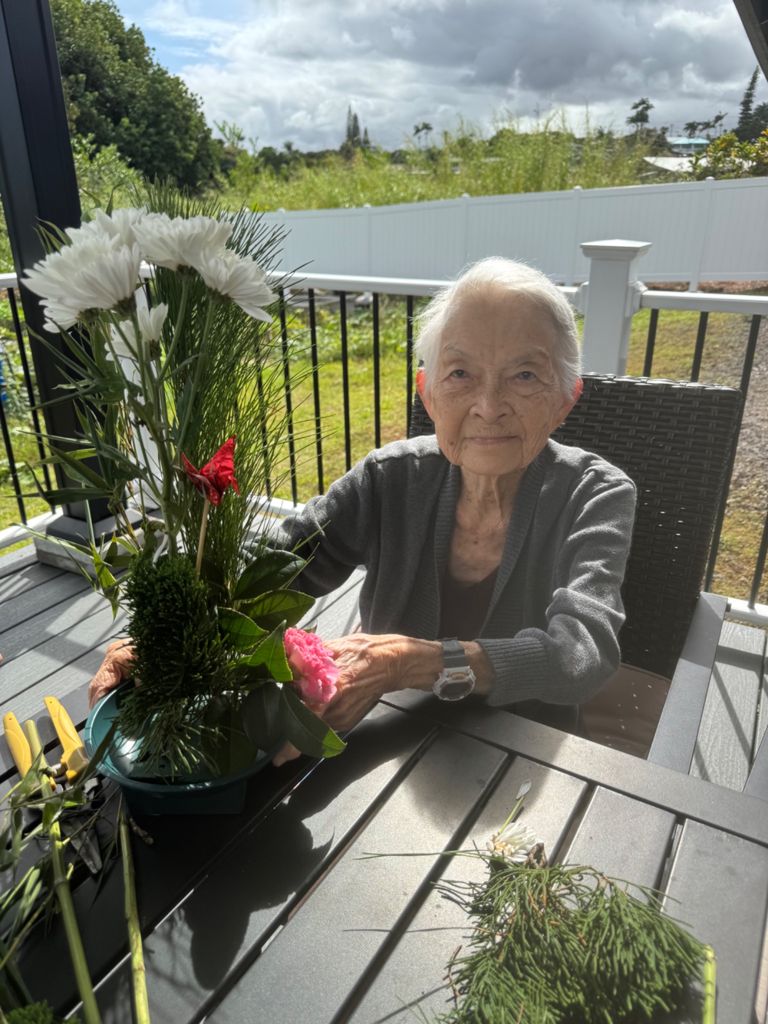 Resident arranging flowers on the lanai