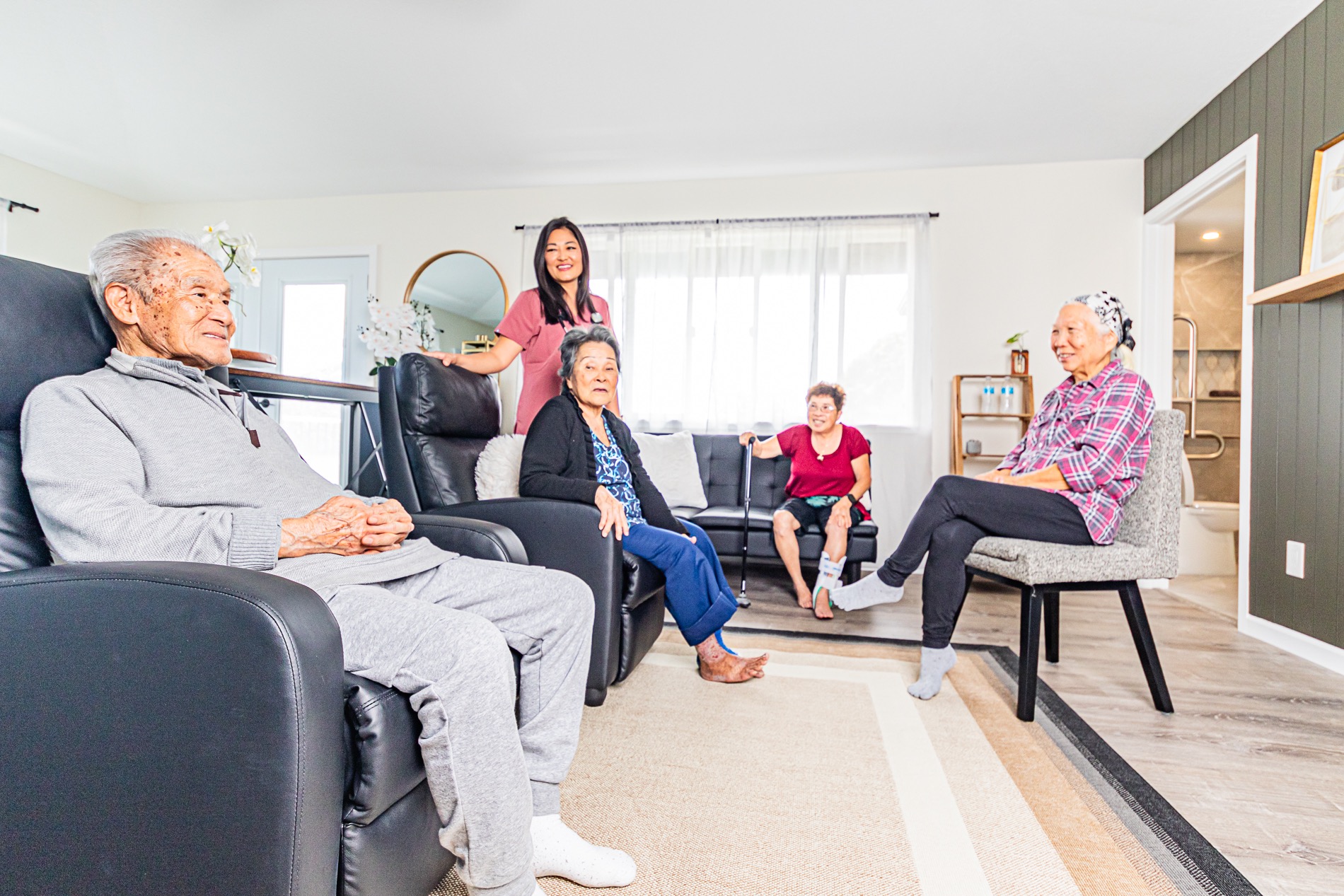 Jill with residents gathered in the living room
